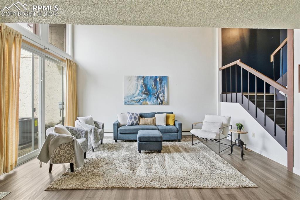 Living room with wood finished floors and stairs