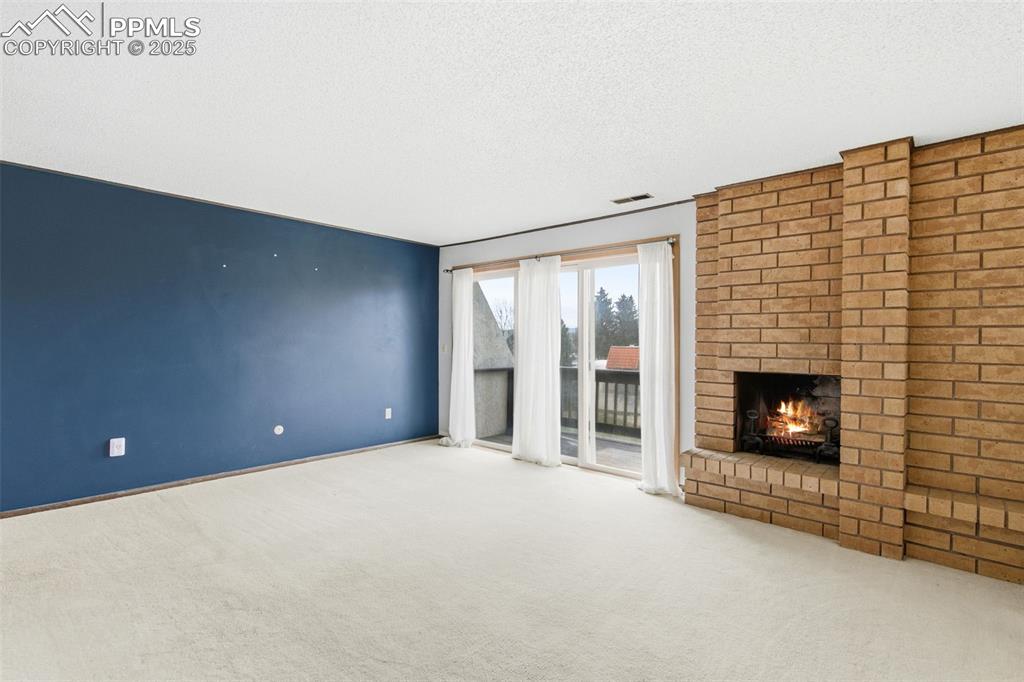 Primary Bedroom  featuring a brick fireplace