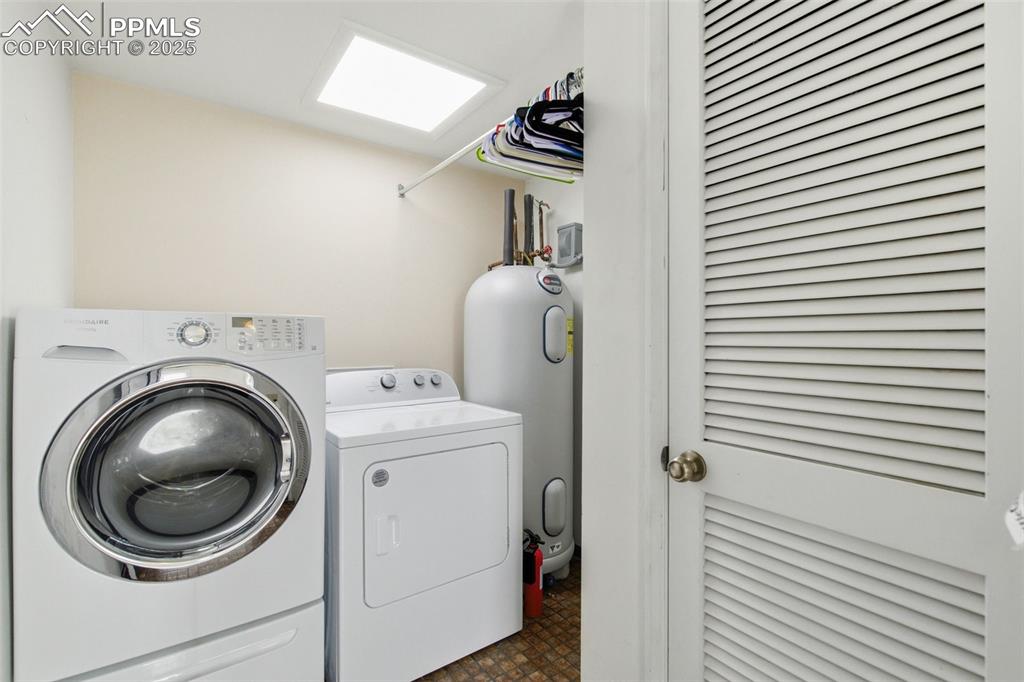 Laundry room with washer and clothes dryer and water heater