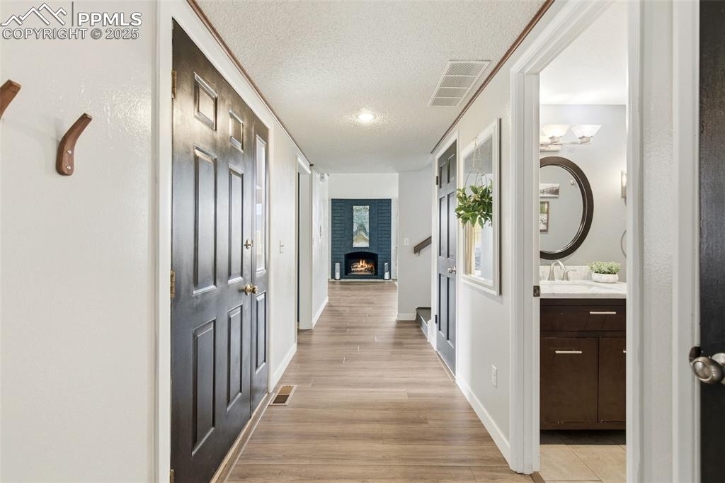 Hall featuring light wood finished floors