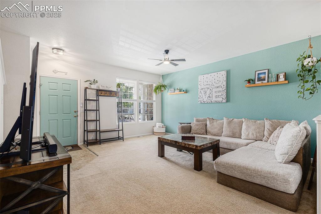 Spacious carpeted Living room with updated ceiling fan