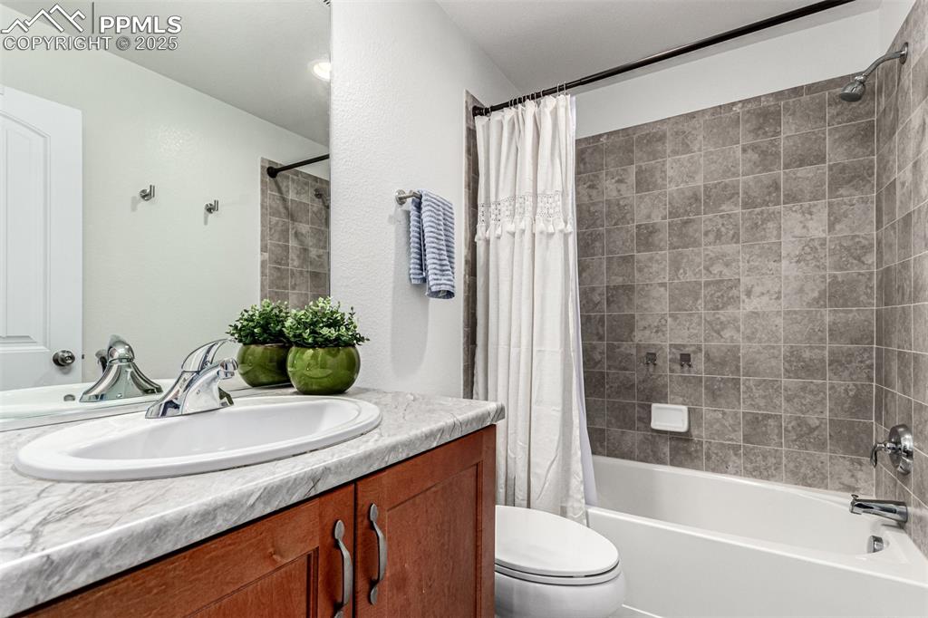 Bathroom with vanity and shower / tub combo with curtain
