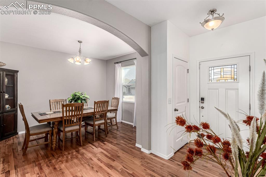 Entryway featuring arched walkways, wood finished floors, and healthy amount of natural light