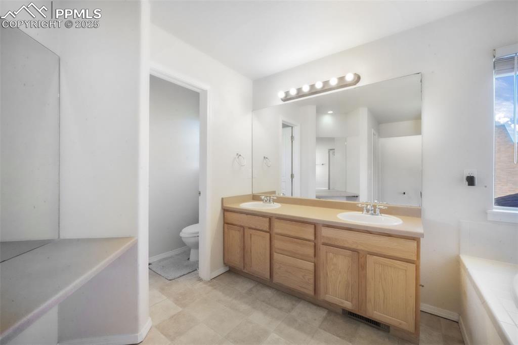 Full bathroom with double vanity and a bathtub