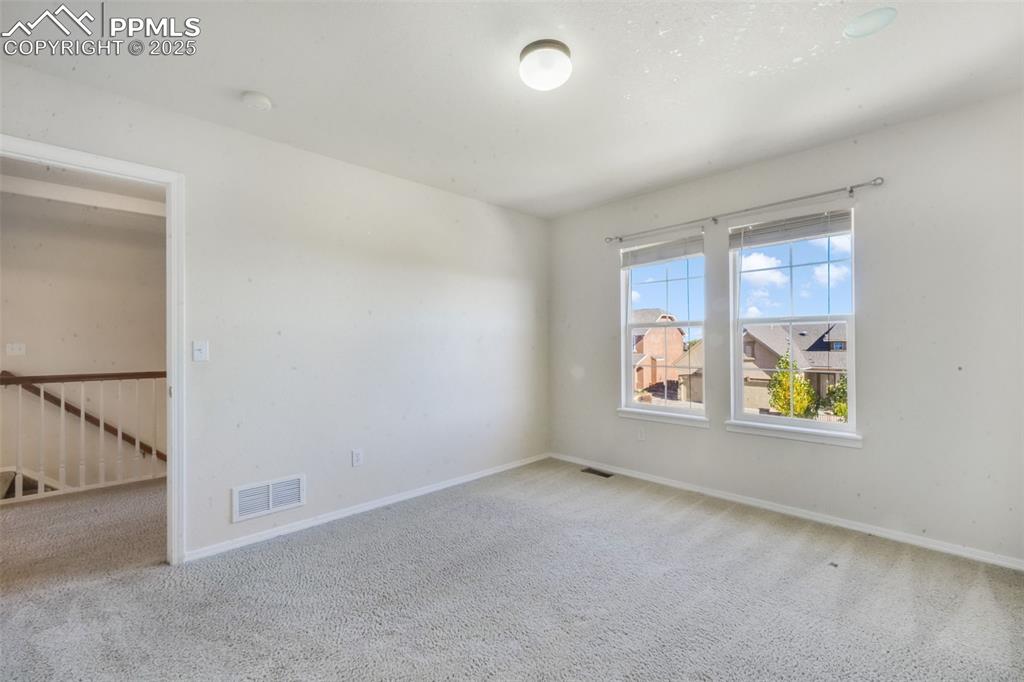 Carpeted spare room with baseboards