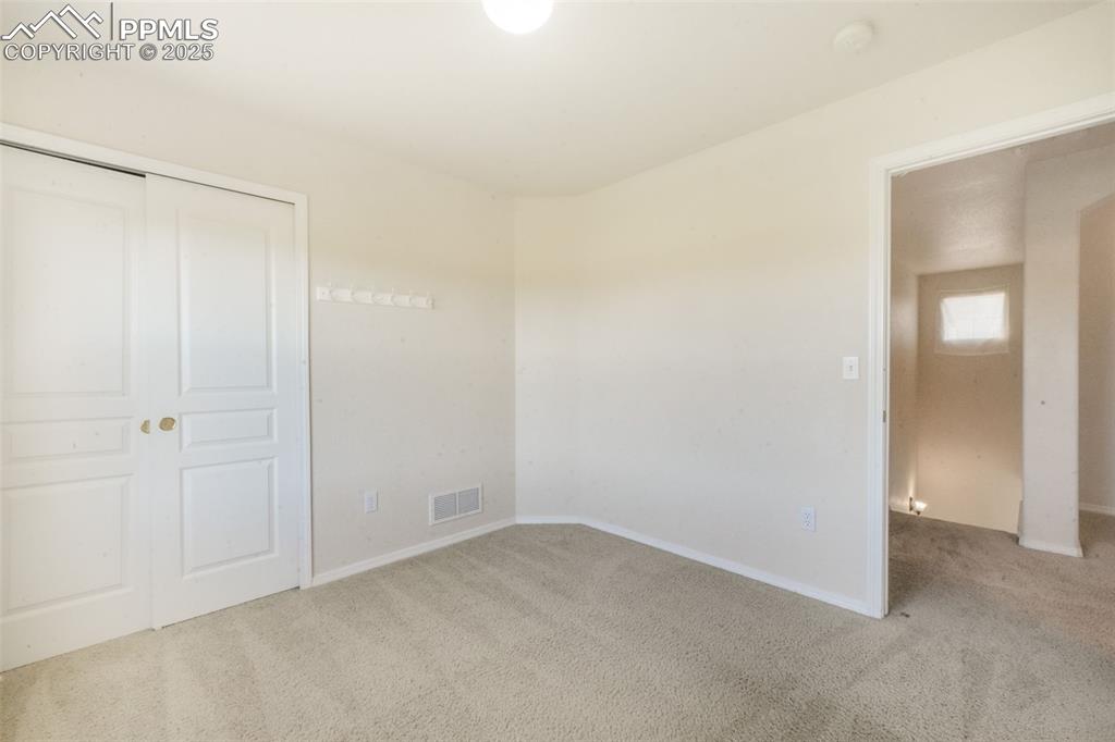 Unfurnished bedroom featuring carpet floors and a closet