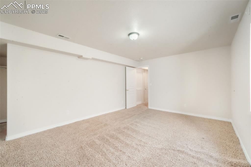 Unfurnished bedroom featuring carpet floors and baseboards