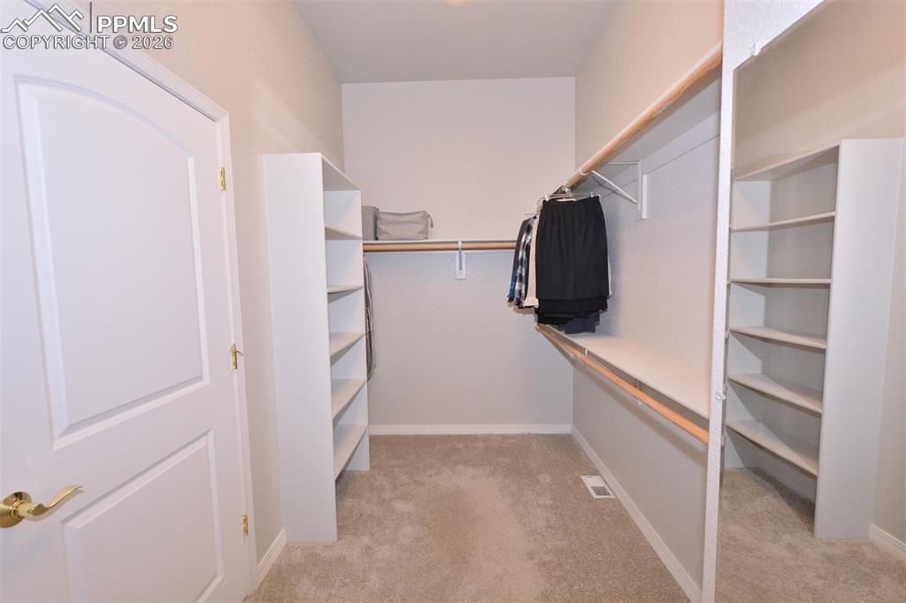 Primary bedroom walk-in closet