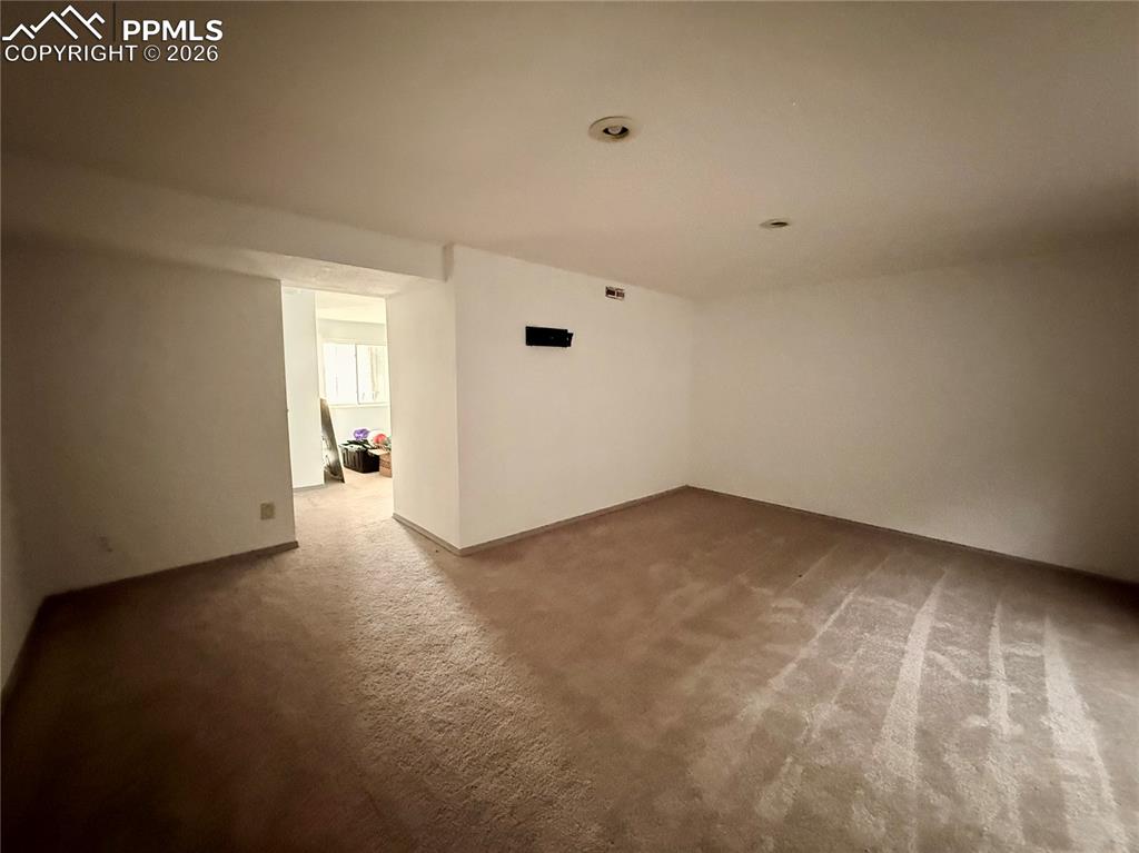 Empty room with carpet floors