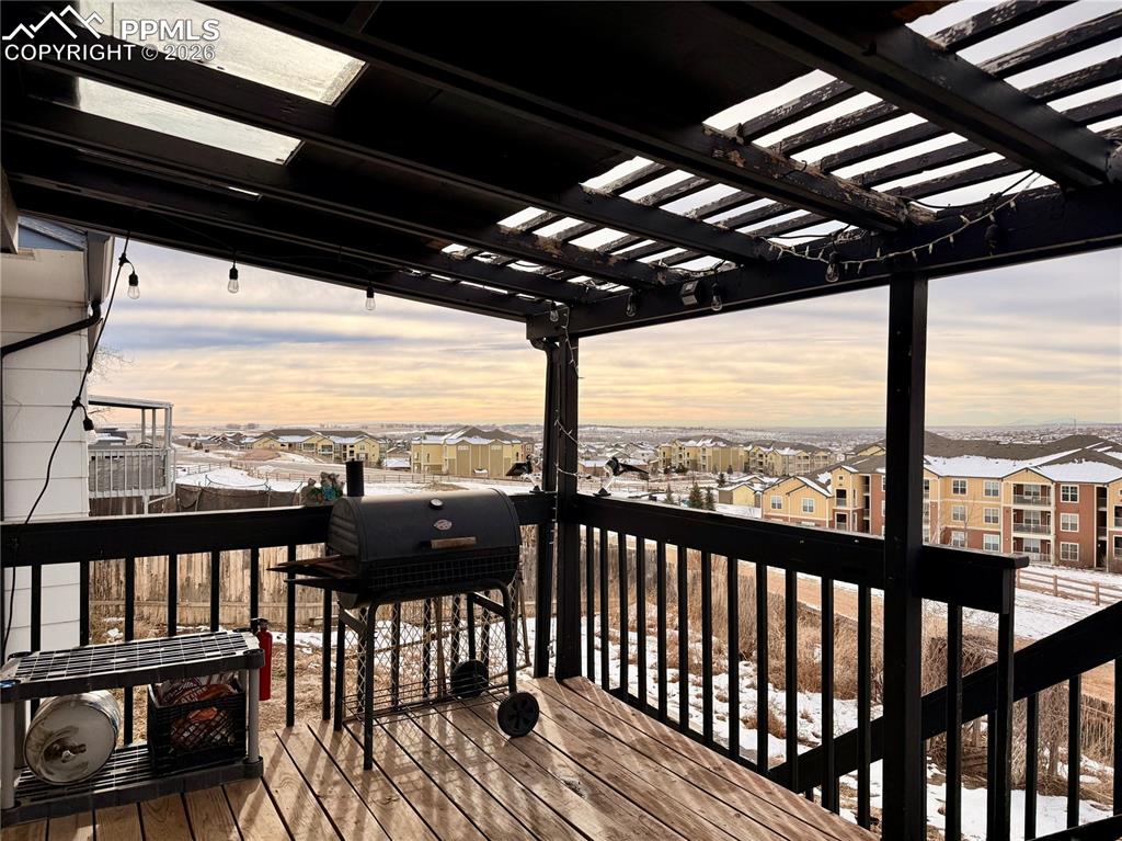 Deck featuring grilling area, a residential view, and a pergola