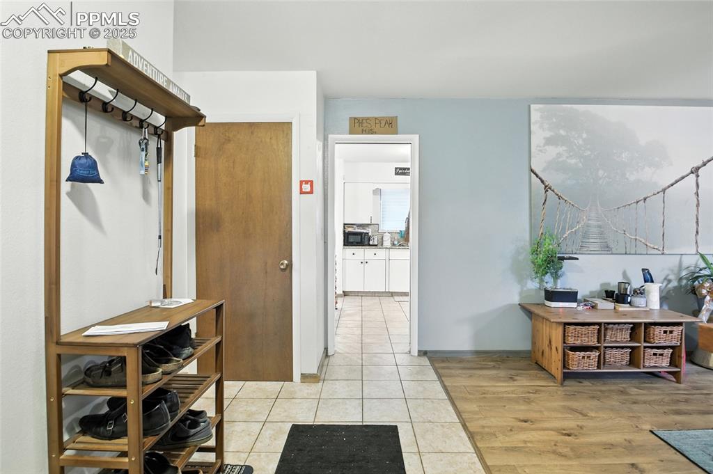 Hall featuring light tile patterned floors