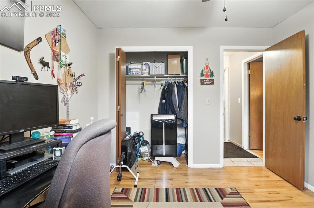 Office space featuring light wood finished floors and ceiling fan