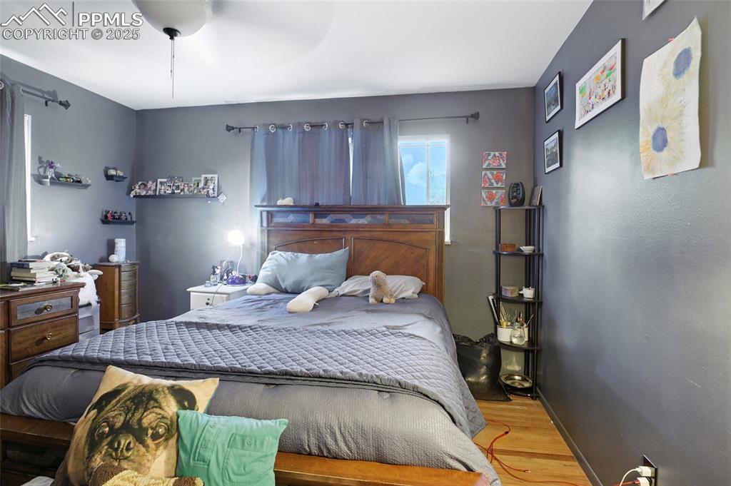 Bedroom with wood finished floors and a ceiling fan