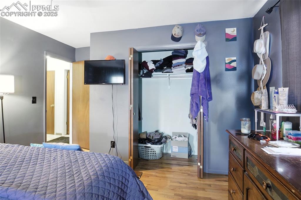 Bedroom with light wood-style floors and a closet