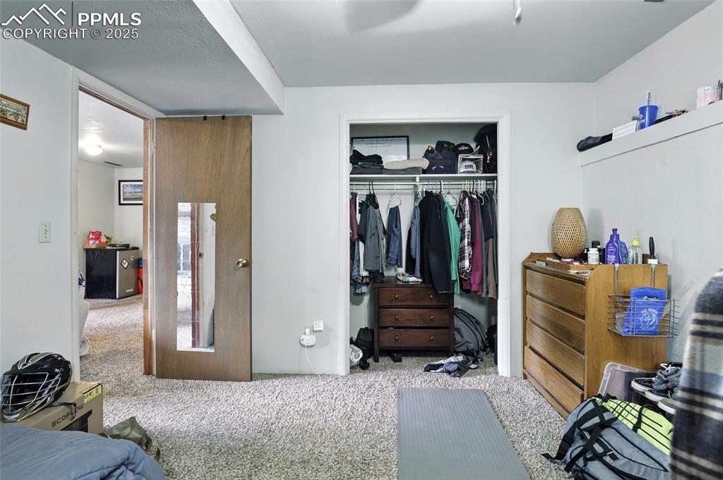 Bedroom with carpet flooring and a closet