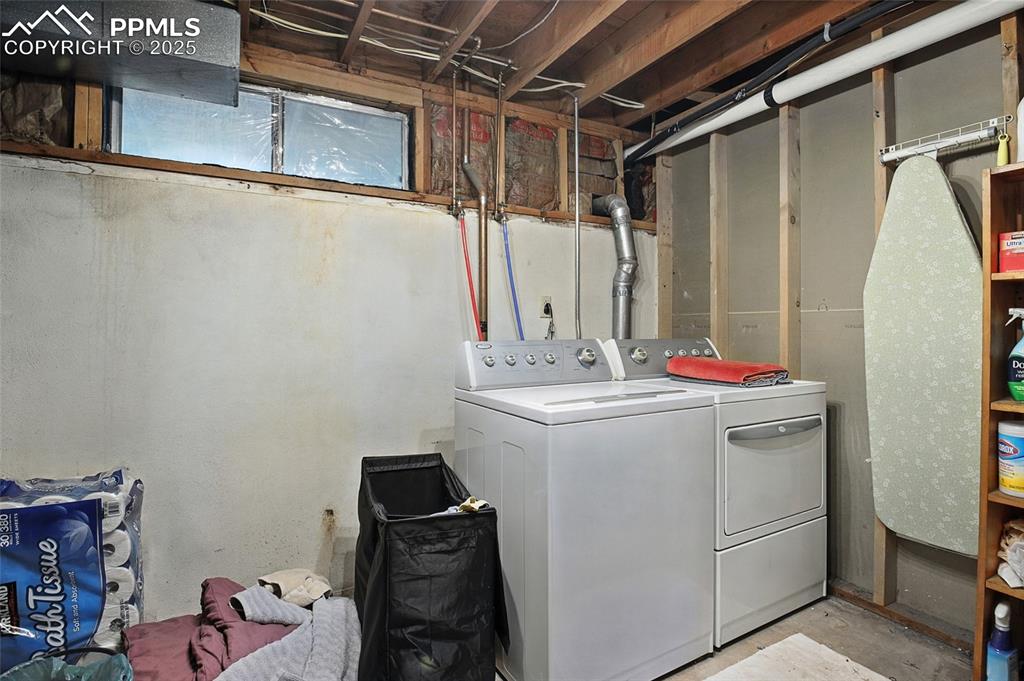 Laundry area with washing machine and clothes dryer
