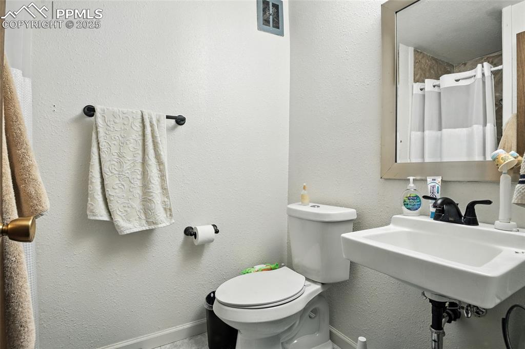 Full bathroom featuring a textured wall