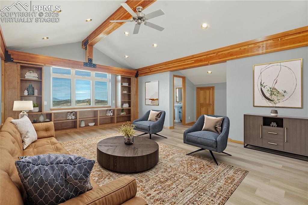 Virtually Staged - Living area with light wood-type flooring, built in features, recessed lighting, and a ceiling fan