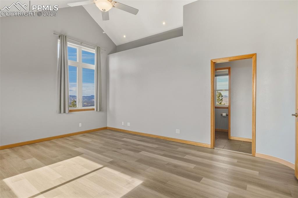 Unfurnished room with plenty of natural light, high vaulted ceiling, light wood-style flooring, a ceiling fan, and recessed lighting