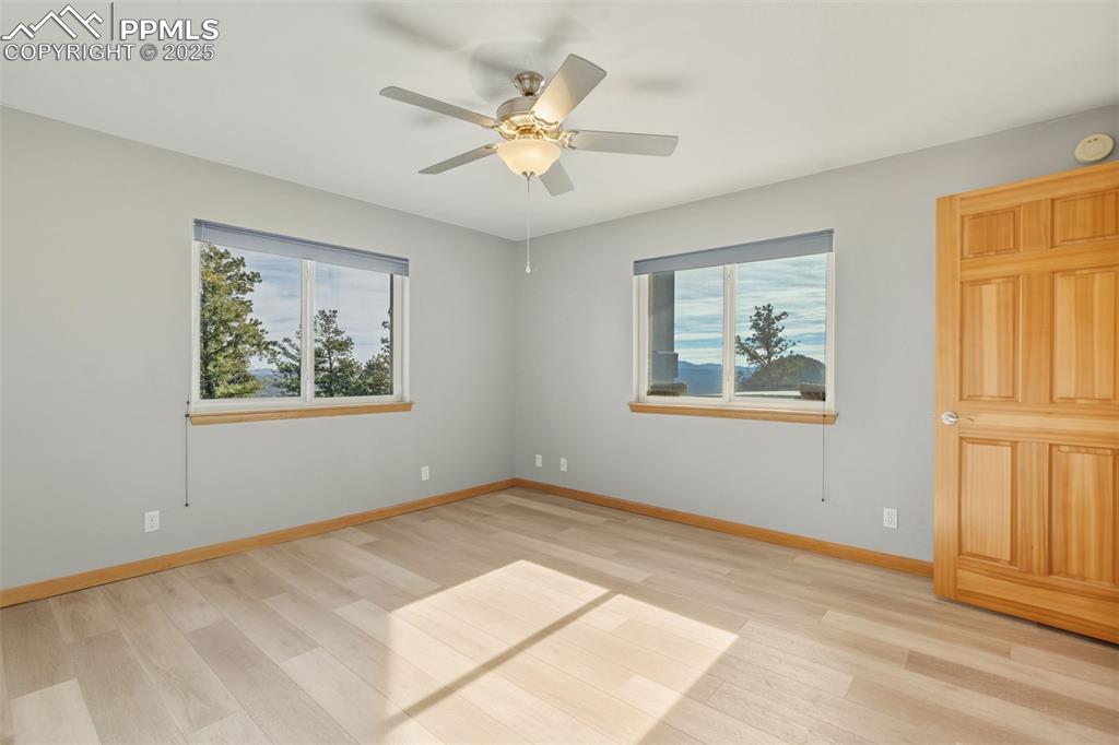 Spare room featuring light wood-style floors and a ceiling fan