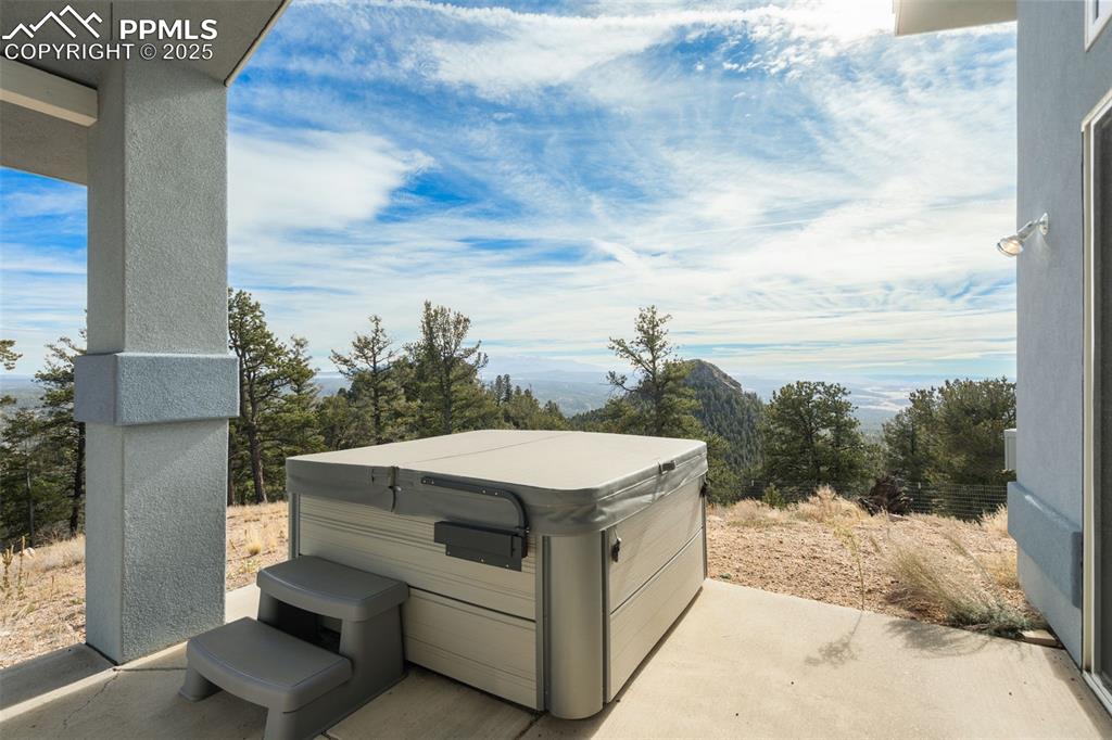 View of patio with a hot tub