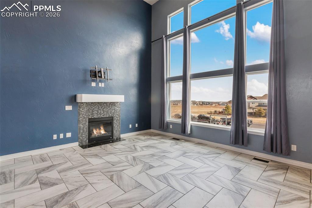 Light-filled family room featuring a beautiful fireplace 