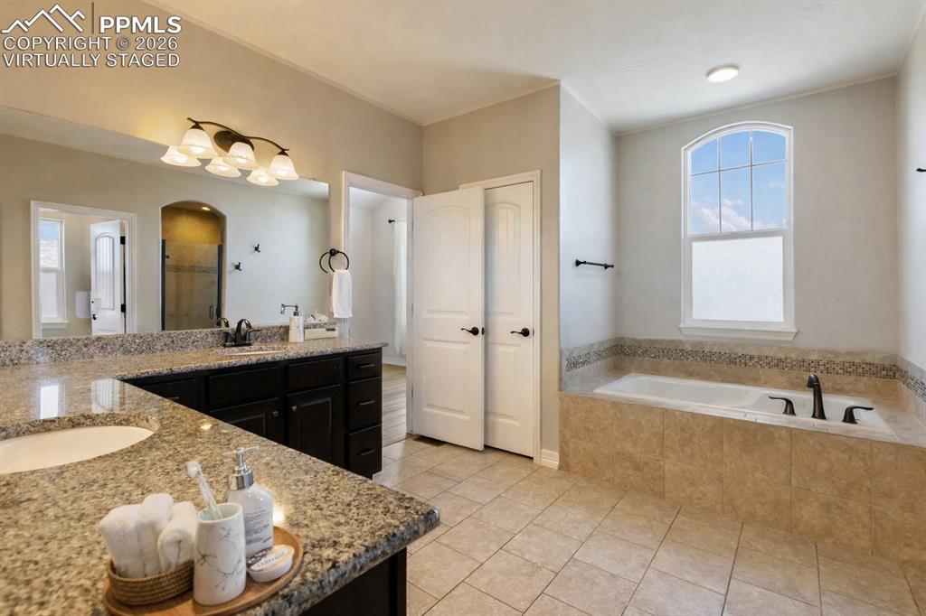 Your personal spa offering dual sinks and tranquil tub (Virtually Staged) 