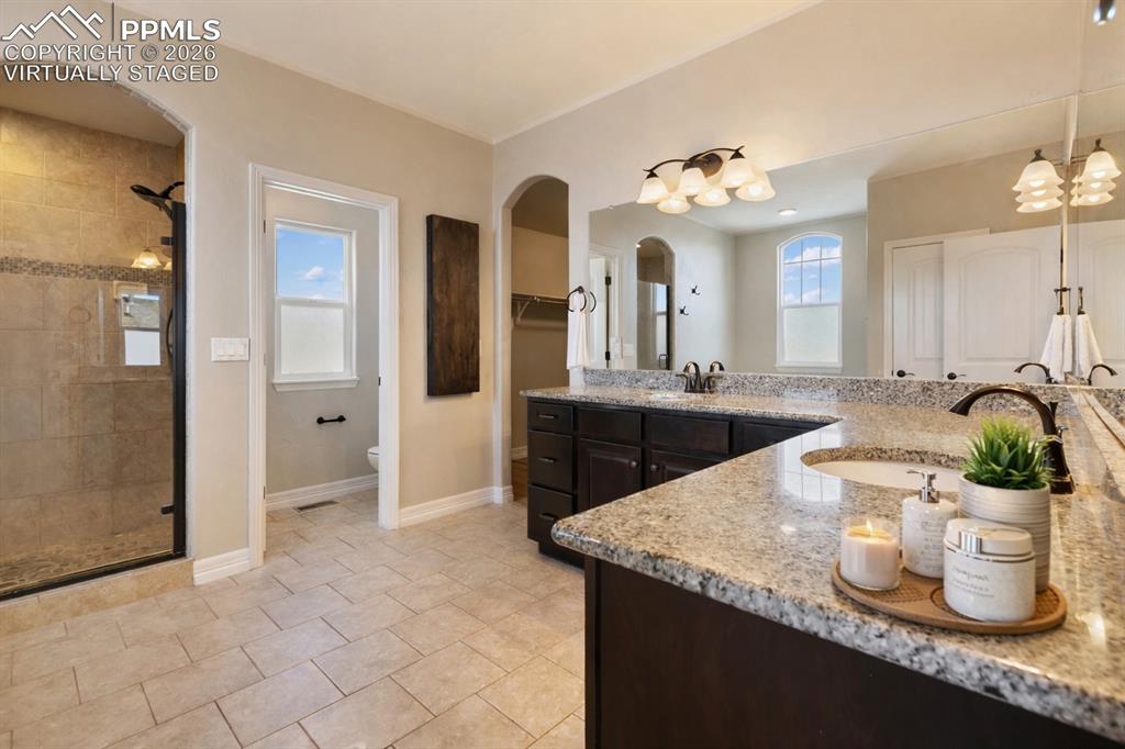 Well-designed primary bathroom with a modern feel (Virtually Staged)