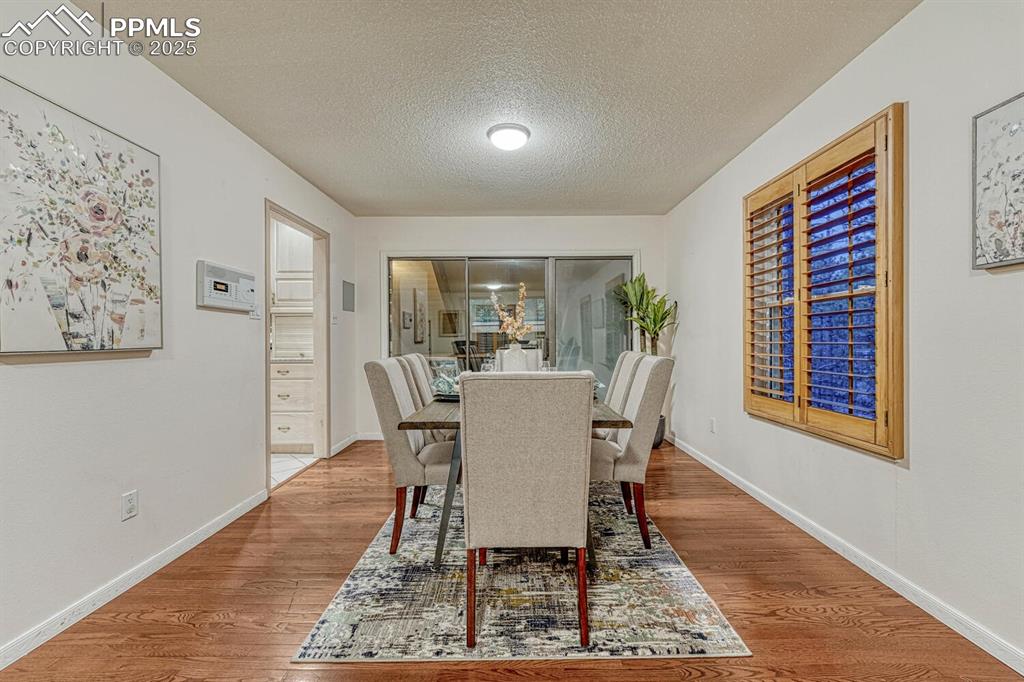 The Formal Dining Room has gorgeous hardwood floors and a slider to a balcony overlooking the indoor pool and hot tub.