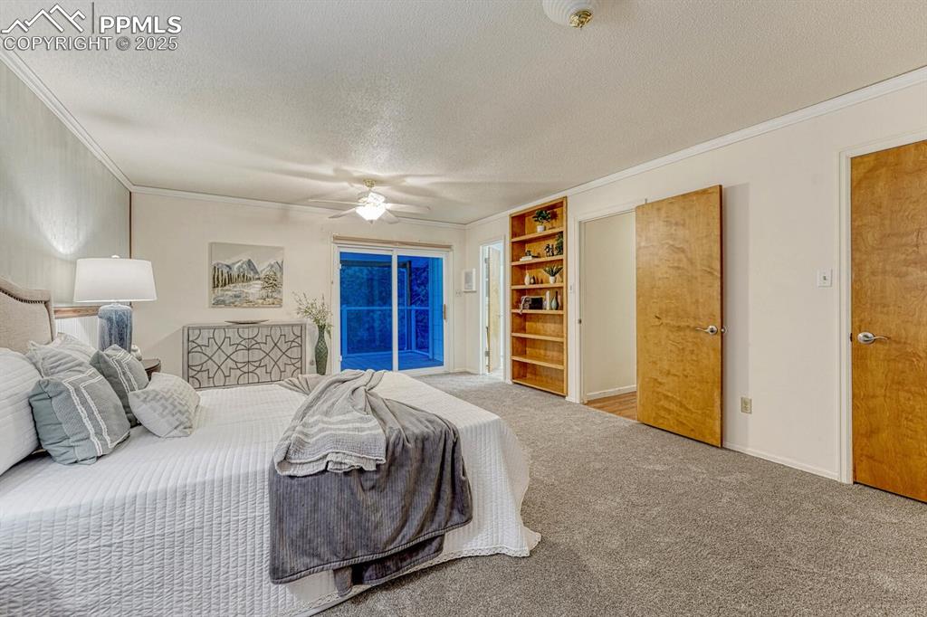 The upper level Primary Bedroom has a slider to a private, enclosed balcony to relax and enjoy the amazing beauty of the treed lot.