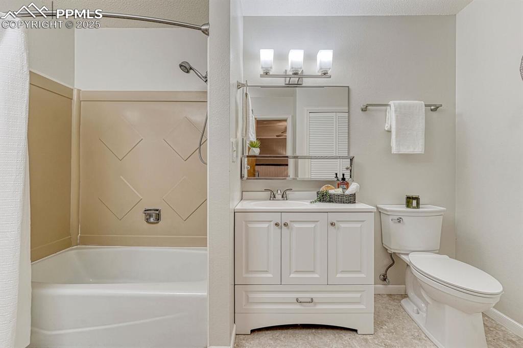 The updated Primary Bathroom offers a vanity, mirror, and tub/shower.