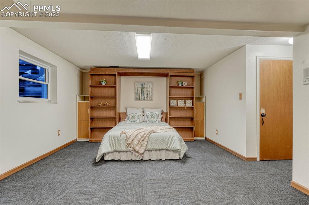 Comfortable built-in murphy bed with built-in bookshelves.