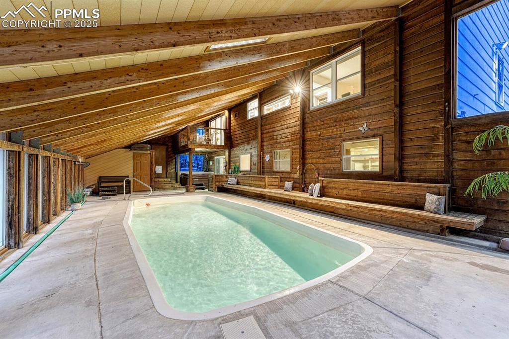 Enjoying swimming in the heated pool year round in this indoor pool and hot tub room.
