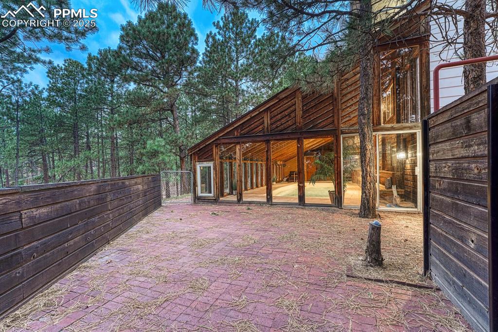 Large fenced, brick patio for outdoor dining, entertaining, and relaxation.