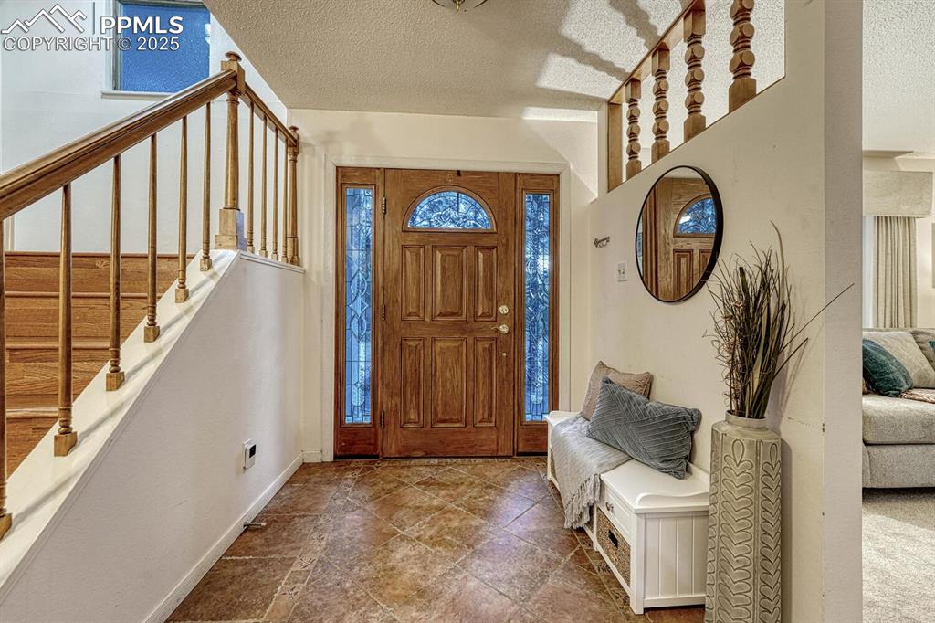Front Entry with tile floor and gorgeous wood front door with stained glass side lites.
