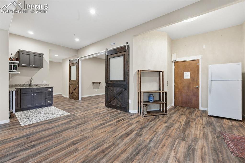 Kitchenette or wetbar off the family room. The door to the elevator is on the right, doors to a future theater in the center
