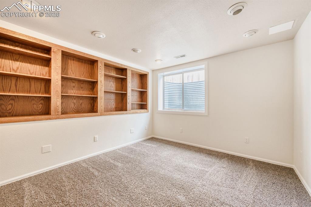 Basement bedroom with built-in book cases