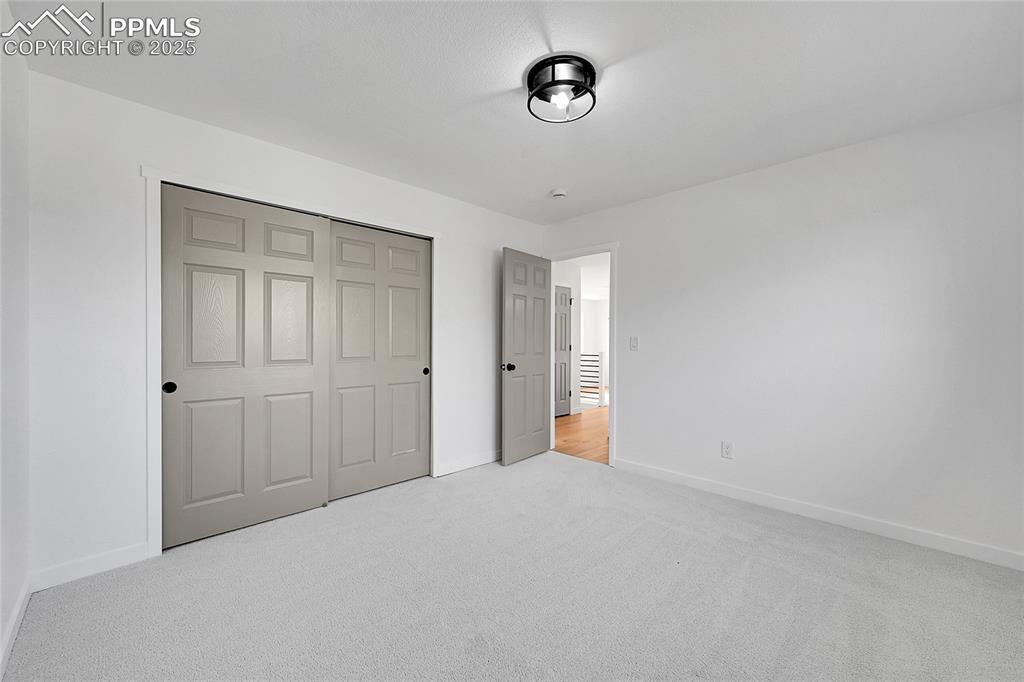 Unfurnished bedroom with carpet and a closet