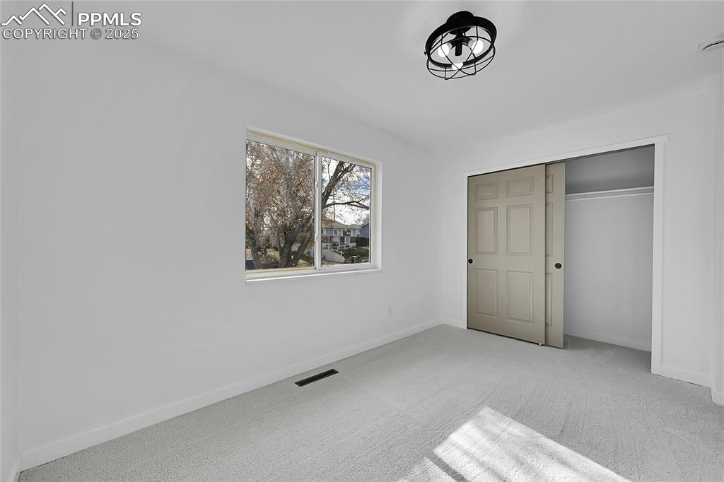 Unfurnished bedroom with carpet floors and a closet