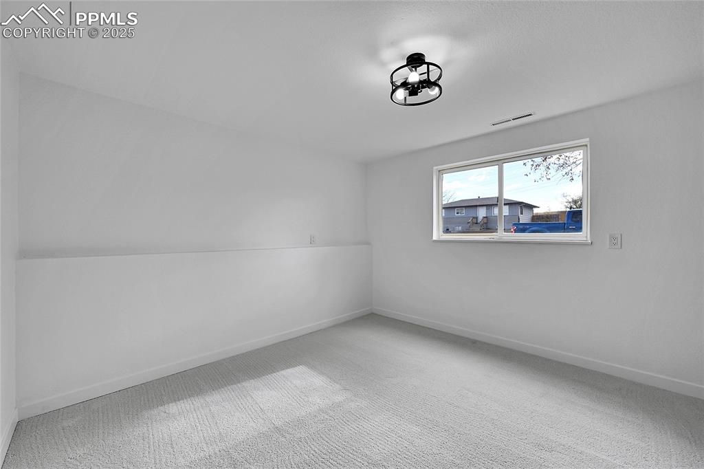 Bonus room with carpet and baseboards