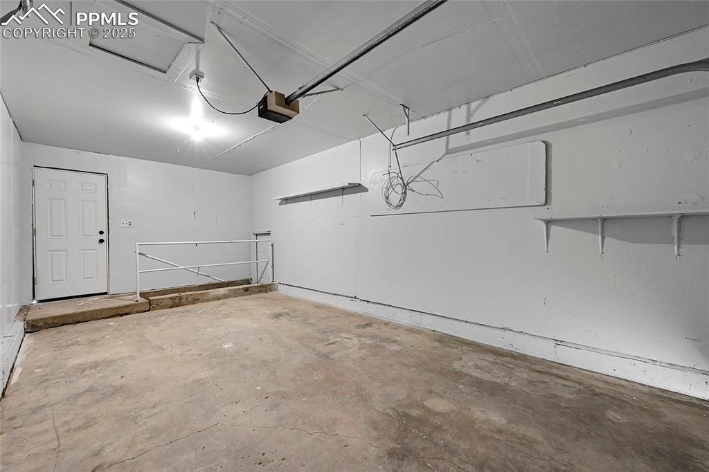 Garage featuring a garage door opener
