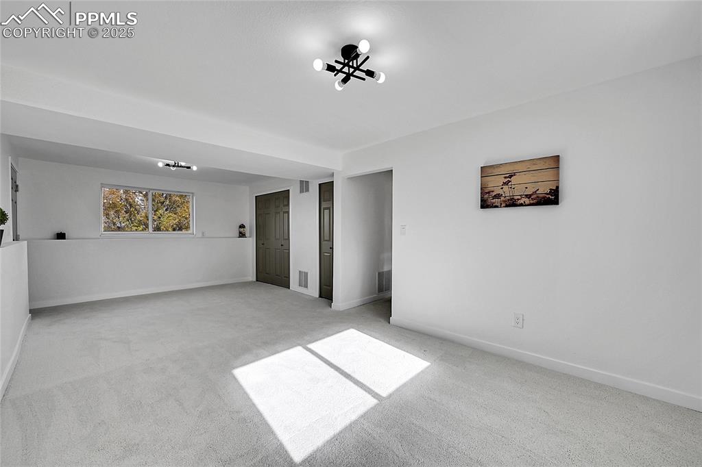 Carpeted empty room with baseboards