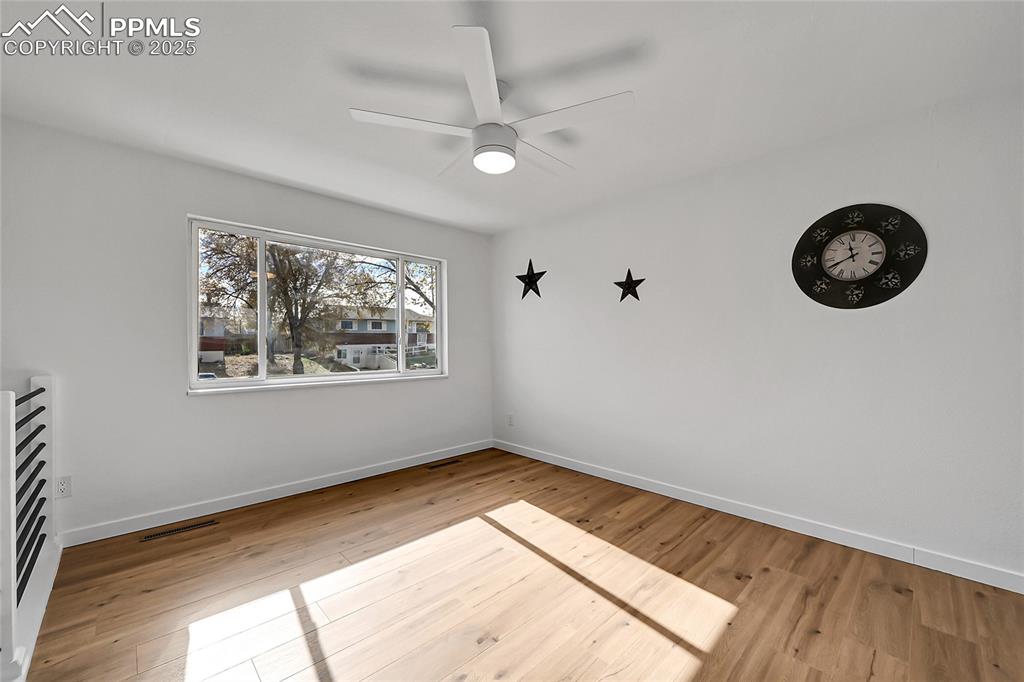 Unfurnished room with light wood-style floors and ceiling fan