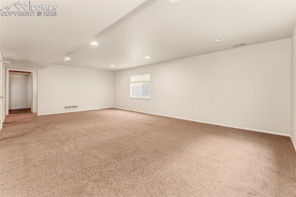 Bedroom #4 looking into the hallway at the linen closet next to the basement bathroom.