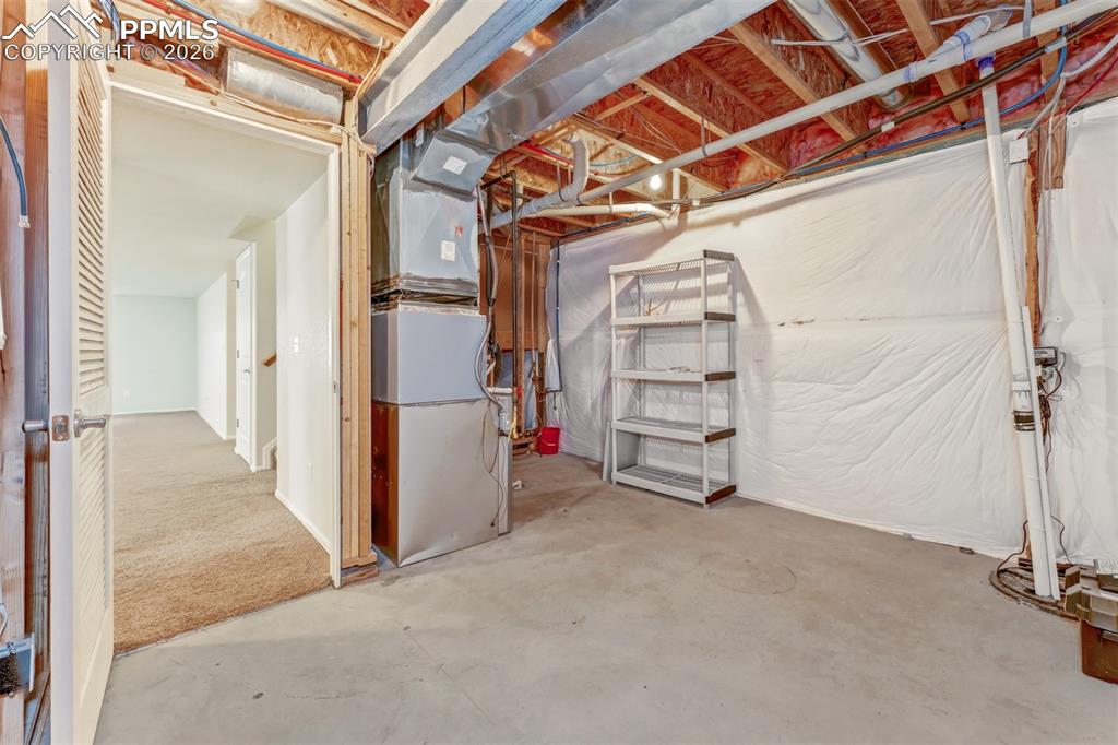 Large concrete patio and nicely landscaped backyard with sprinkler system.