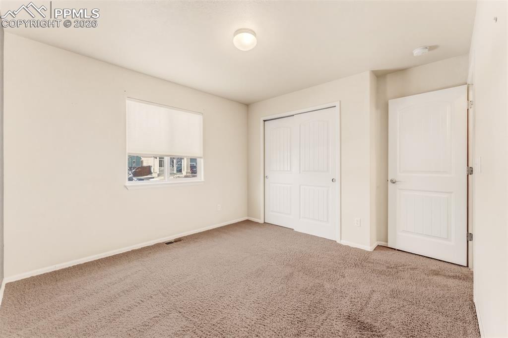 Living Room, looking towards the kitchen and dining room with a walkout to the backyard.