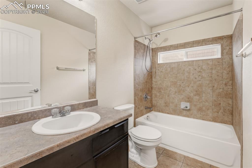 Kitchen with granite countertops, large center island, stainless steel appliances and dark cabinets.