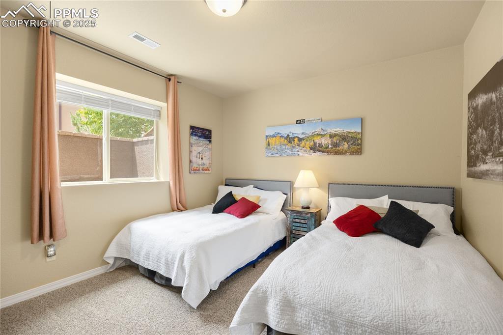 Carpeted bedroom featuring baseboards