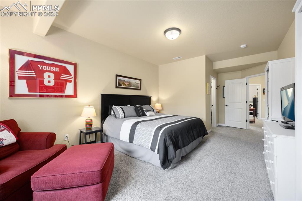 Bedroom featuring light colored carpet