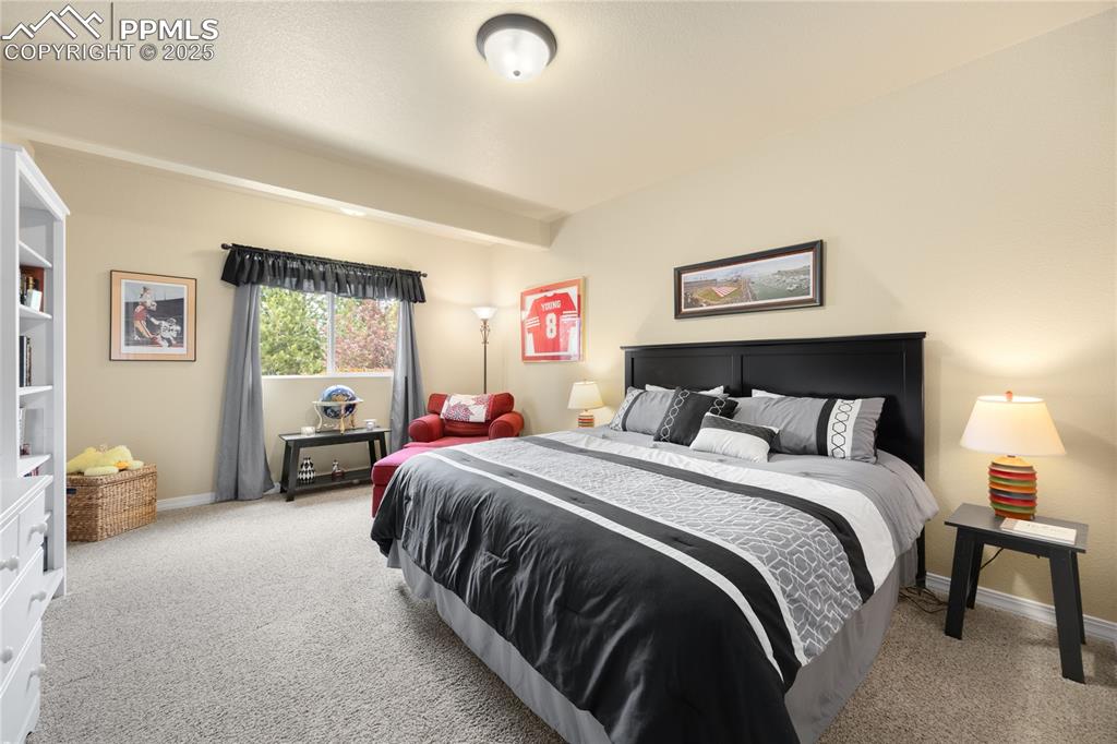 Carpeted bedroom featuring baseboards